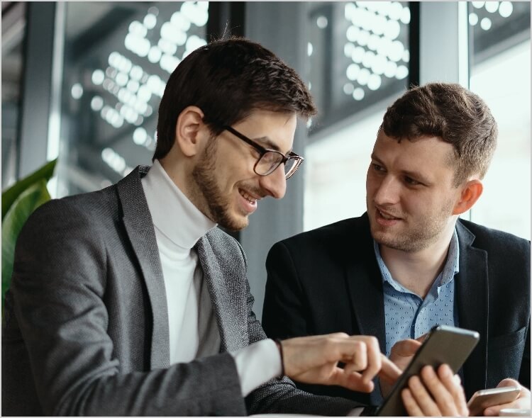 two businessmen having conversation using smartphone